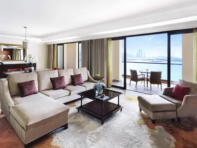 a living room with a couch and a table at Fairmont The Palm in Dubai