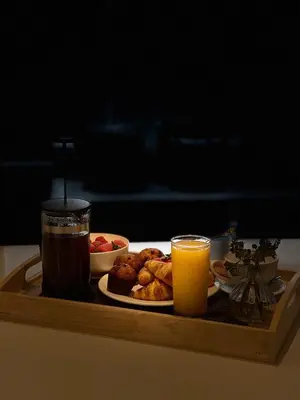a tray with a plate of food and two glasses of juice at Westminster Burj Residences in Dubai