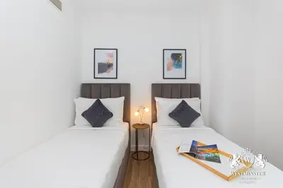 two beds sitting next to each other in a room at Westminster Burj Residences in Dubai