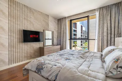 a bedroom with a bed and a tv on a wall at City walk apartment Specter in Dubai