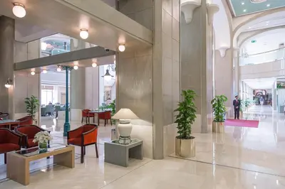 a lobby with chairs and tables in a building at Millennium Plaza Downtown Suites in Dubai