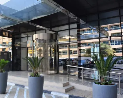 a building with two potted plants in front of it at Millennium Place Dubai Marina in Dubai