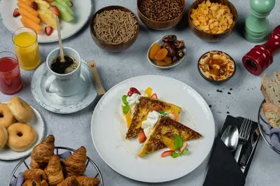 a table topped with plates of food and snacks at Millennium Place Dubai Marina in Dubai