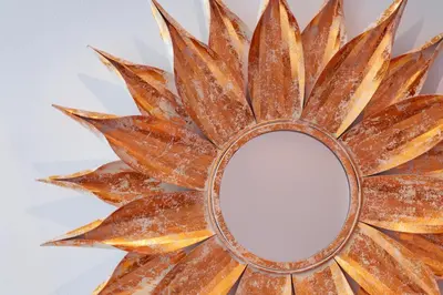 a mirror in the shape of a sunburstburst against a wall at Elite Royal Apartment - Full Burj Khalifa & Fountain View - Royal in Dubai