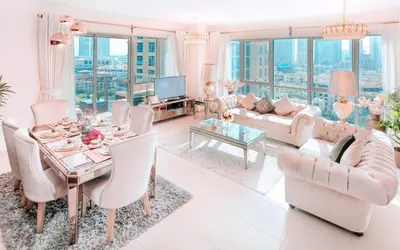 a living room filled with furniture and a table at Elite Royal Apartment - Full Burj Khalifa & fountain view - Pearl in Dubai