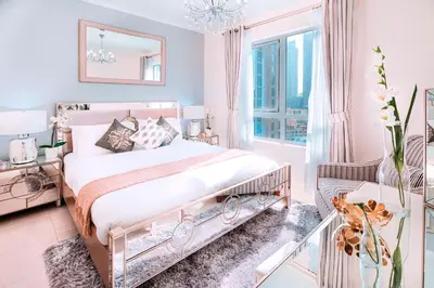 a bedroom with a bed and a glass table at Elite Royal Apartment - Full Burj Khalifa & fountain view - Pearl in Dubai