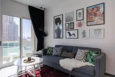 a living room with a couch and a table at Wow! Super Luxury Apartment in Dubai Marina - 1BR RO in Dubai