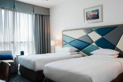 a hotel room with two beds and a window at Roda Al Murooj Residences in Dubai