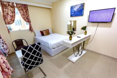 a small room with a bed and a television at comfortable Rooms For Girls in Marina Dubai, the best offer in Dubai