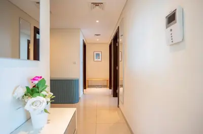a hallway of a hospital with a vase of flowers at New Arabian -Panorama 2 BR Full Golf course View in Dubai