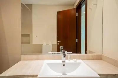 a bathroom with a sink and a large mirror at New Arabian -Panorama 2 BR Full Golf course View in Dubai