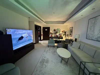 a living room with a couch and a flat screen tv at Downtown Al Bahar Apartments in Dubai