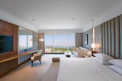 a hotel room with a large bed and a television at Grand Hyatt Dubai Resort & Waterpark in Dubai