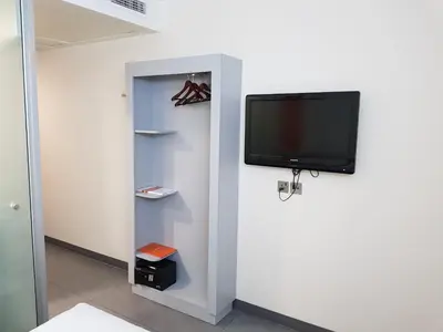 a flat screen tv on a wall in a room at JOIN INN HOTEL Jebel Ali, Dubai - Formerly easyHotel Jebel Ali in Dubai