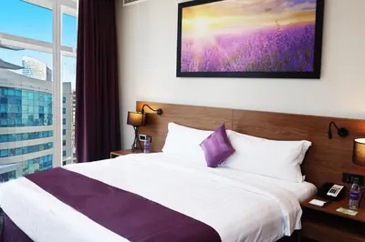 a hotel room with a large bed and a window at Park Regis Business Bay in Dubai