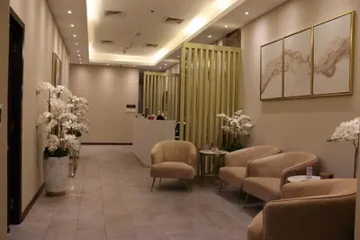 a waiting room with chairs and a table and flowers at Park Regis Business Bay in Dubai