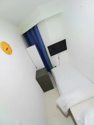 a small room with two beds and a television at Nice Single Rooms for 