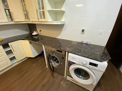 a kitchen with a washing machine and a counter at Nice Single Rooms for 