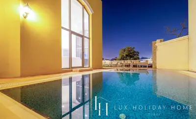 a swimming pool in the middle of a house at LUX - The Ocean Pearl Villa in Dubai