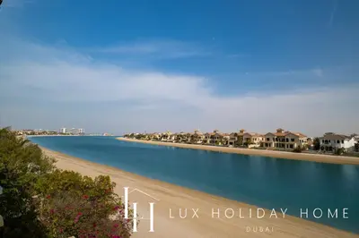 a view of a beach with houses in the distance at LUX - The Ocean Pearl Villa in Dubai
