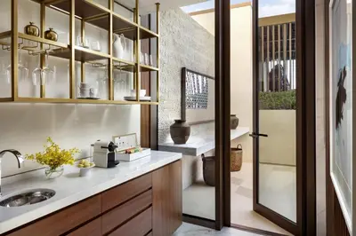 a kitchen with a sink and a glass door at Atlantis The Royal in Dubai
