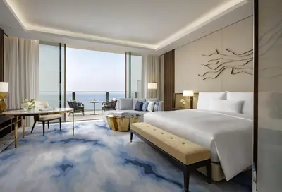 a bedroom with a bed and a living room with a view at Atlantis The Royal in Dubai