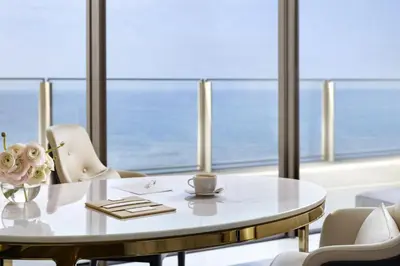 a table and chairs in a room with a view of the ocean at Atlantis The Royal in Dubai