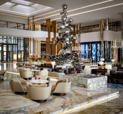 a lobby of a hotel with a large chandelier at Atlantis The Royal in Dubai