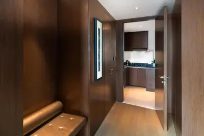 a small room with a hallway with a kitchen at Paramount Hotel Dubai in Dubai