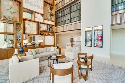 a living room with white furniture and wooden ceilings at Vida Downtown Residences in Dubai