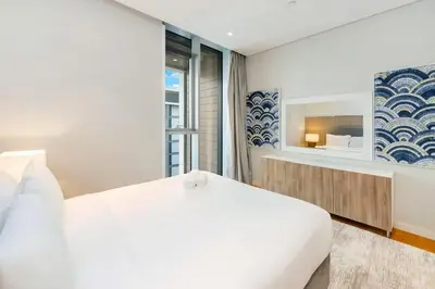 a bedroom with a white bed and a window at FAM Living Bluewaters - Island Living - Ain Dubai & Sea View in Dubai