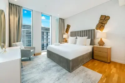 a bedroom with a large bed and a large window at FAM Living Bluewaters - Island Living - Ain Dubai & Sea View in Dubai