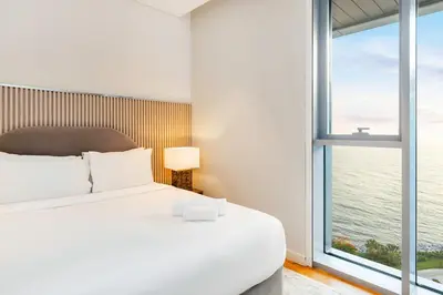 a bedroom with a bed and a large window at FAM Living Bluewaters - Island Living - Ain Dubai & Sea View in Dubai