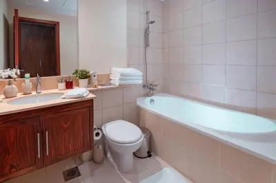 a bathroom with a tub and a toilet and a sink at Elite Royal Apartment - Full Burj Khalifa & Fountain View - 2 bedrooms and 1 open bedroom without partition in Dubai