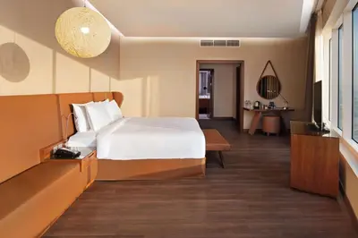 a hotel room with a bed and a television at Radisson Blu Hotel, Dubai Canal View in Dubai