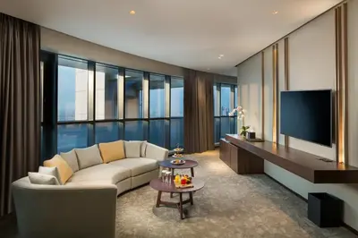 a living room with a couch and a tv at Millennium Place Barsha Heights Hotel in Dubai