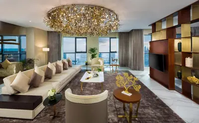 a living room with a couch and a chandelier at Millennium Place Barsha Heights Hotel Apartments in Dubai