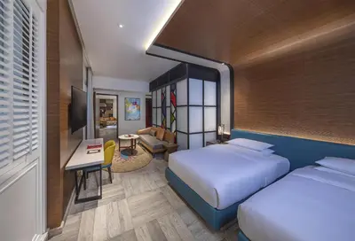 a hotel room with two beds and a desk at Andaz Dubai The Palm, By Hyatt in Dubai