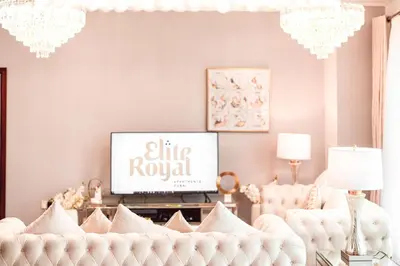 a living room with a white couch and a tv at Elite Royal Apartment - Full Burj Khalifa and Fountain View - The Royal in Dubai