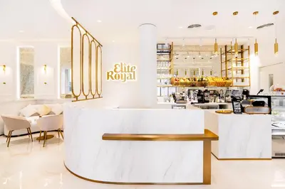 a lobby of a restaurant with a white counter at Elite Royal Apartment - Full Burj Khalifa and Fountain View - The Royal in Dubai