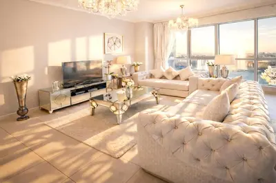 a living room with a large couch and a television at Elite Royal Apartment - Full Burj Khalifa and Fountain View - The Royal in Dubai