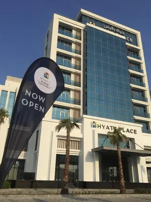 a building with a new open sign in front of it at Hyatt Place Dubai Jumeirah Residences in Dubai