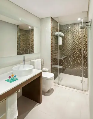 a bathroom with a toilet sink and a shower at Hyatt Place Dubai Jumeirah Residences in Dubai