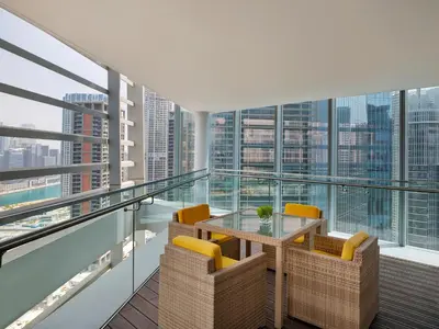 a balcony with a glass table and chairs at Anantara Downtown Dubai in Dubai