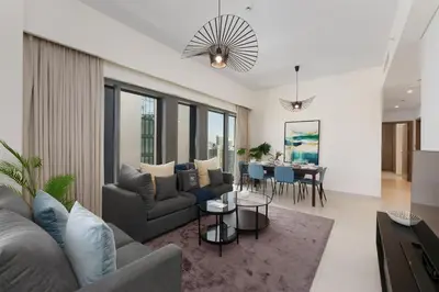 a living room with a couch and a table at Maison Privee - Elevated Living with Spectacular Burj Khalifa Views in Dubai