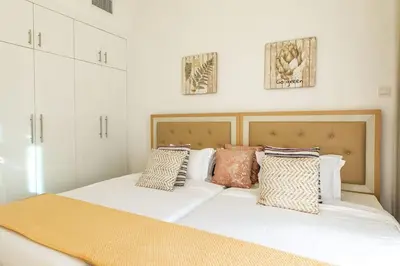 a bedroom with two beds with pillows on it at Continental Tower, Dubai Marina - Luton Vacation Homes in Dubai