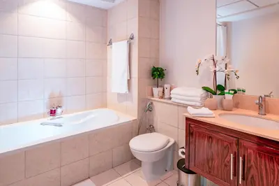 a bathroom with a tub and a toilet and a sink at Elite Royal Apartment - Full Burj Khalifa and Fountain View - Caesar in Dubai