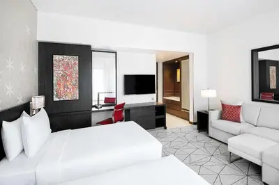 a hotel room with a bed and a couch at Hyatt Place Dubai Jumeirah in Dubai