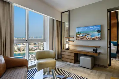 a living room with a couch and a tv at Andaz Family Suites by Hyatt- Palm Jumeirah in Dubai