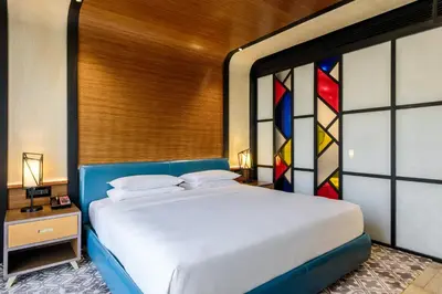 a bedroom with a bed with a stained glass window at Andaz Family Suites by Hyatt- Palm Jumeirah in Dubai